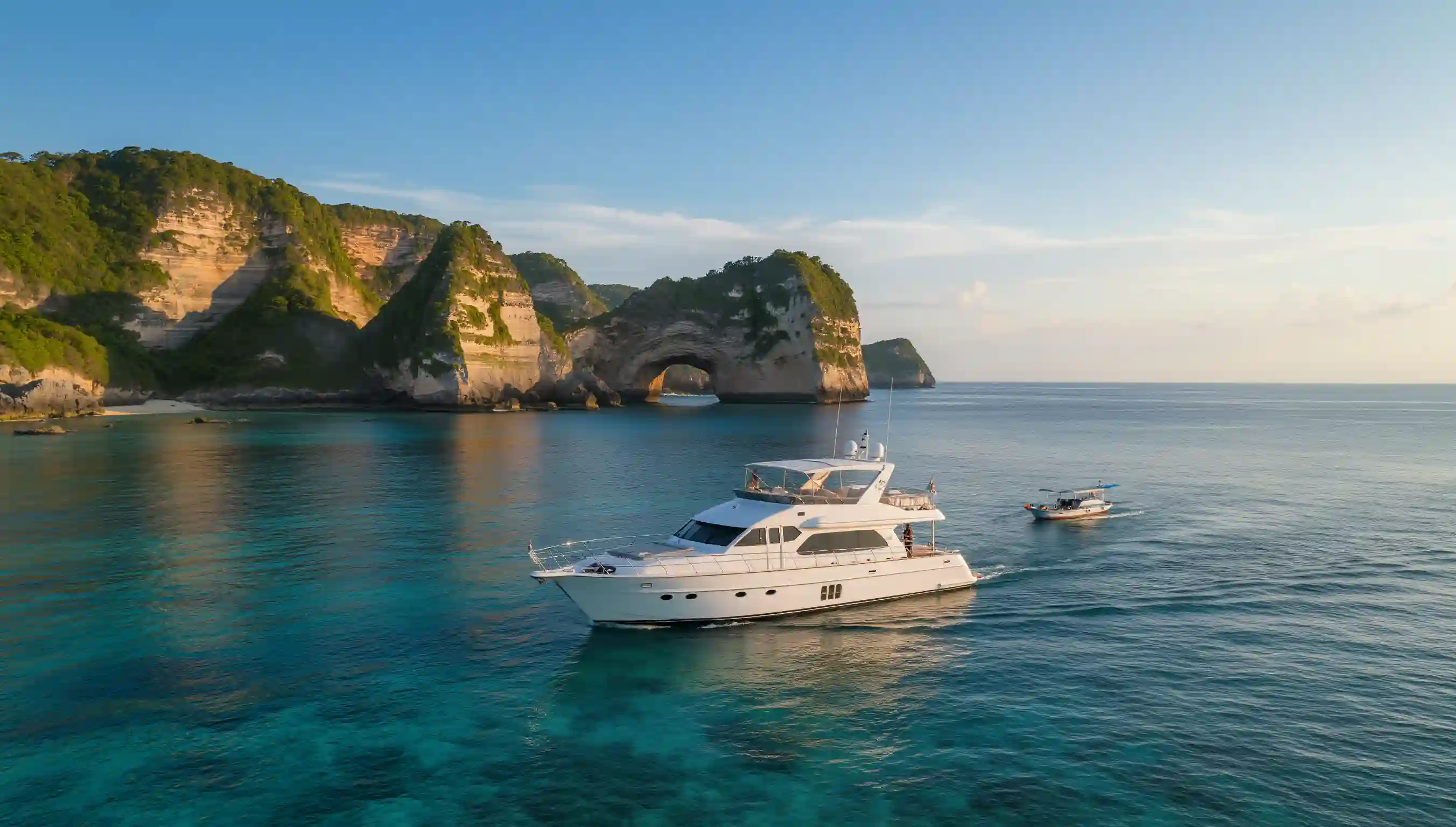 A charter yacht anchored below the cliffs of Nusa Penida