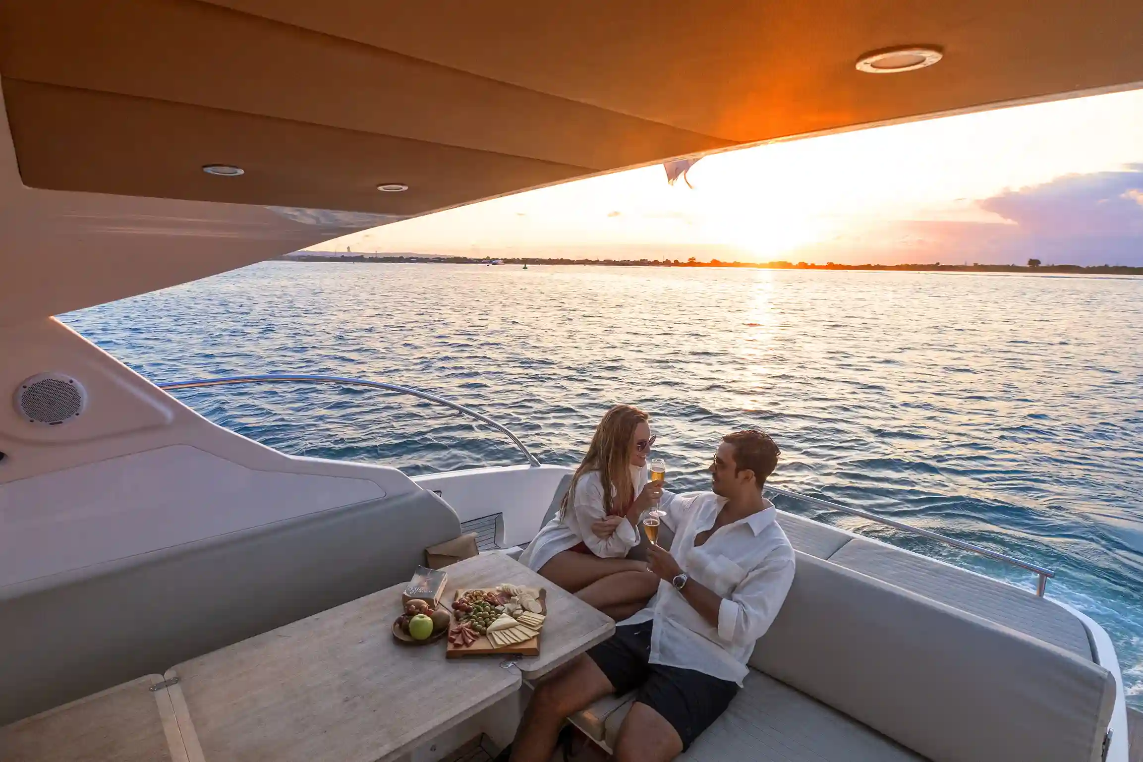 A table set for dinner on the aft deck at sunset